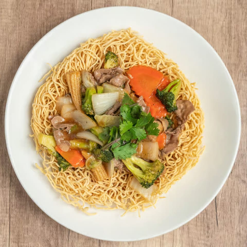 Crispy Vietnamese egg noodles topped with beef, broccoli, carrots, baby corn, and onions.